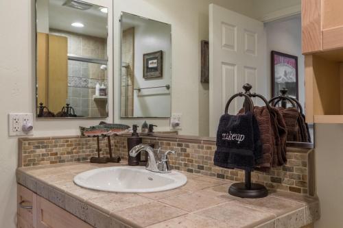 a bathroom with a sink and a mirror at Mammoth Basecamp Condo with Views near Village with AC and Fireplace in Mammoth Lakes