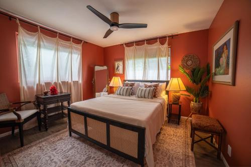a bedroom with a bed and a ceiling fan at Stylized Captain's House in Captain Cook
