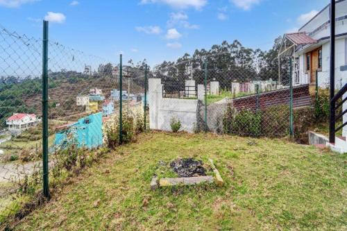 a fenced in yard with a fence at Kodai Mist Starlight Hotels in Kodaikānāl