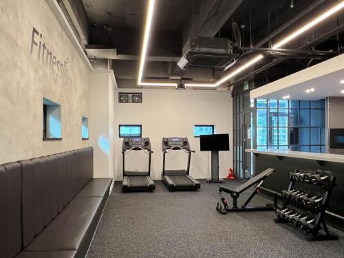 a gym with two treadmills and two machines at Best Western Jeju Hotel in Jeju