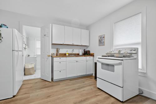 a kitchen with white appliances and white cabinets at Affordable Private Studio in Pensacola