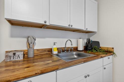 a kitchen with white cabinets and a sink at Affordable Private Studio in Pensacola
