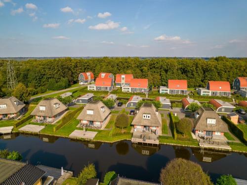 an aerial view of a home on the water at Scenic Holiday Chalet in Drenthe in Midlaren