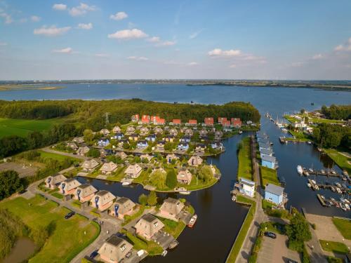 an aerial view of a harbor with houses and boats at Waterfront Villa Near Groningen in Midlaren