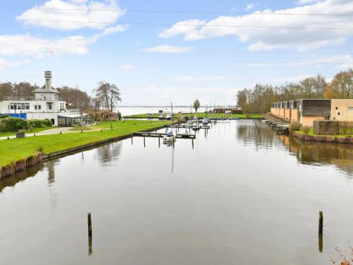 a river with boats in the middle of it at Waterfront Retreat in Drenthe in Midlaren