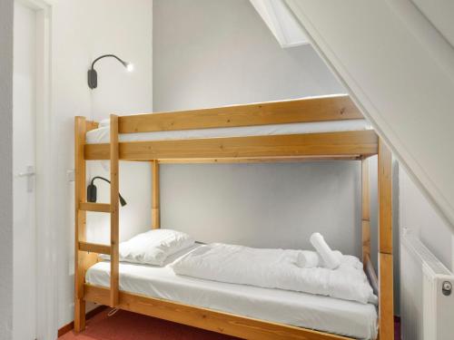 a bunk bed in a room with a staircase at Holiday Home in De Bloemert in Midlaren