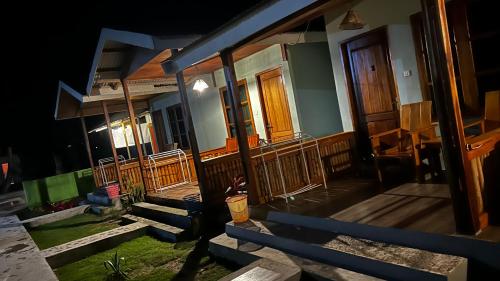 a row of houses with wooden doors and stairs at Renata Cottages in Ohoililir