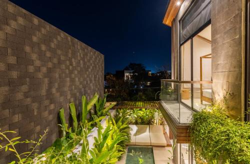 a balcony with plants on the side of a building at Nanna Villa Unit 2 by Betterplace in Tumbak Bayuh