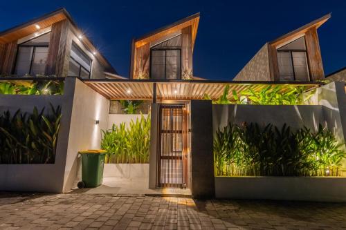 a house with a front door at night at Nanna Villa Unit 2 by Betterplace in Tumbak Bayuh