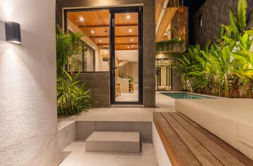 a home with a swimming pool and plants at Nanna Villa Unit 2 by Betterplace in Tumbak Bayuh