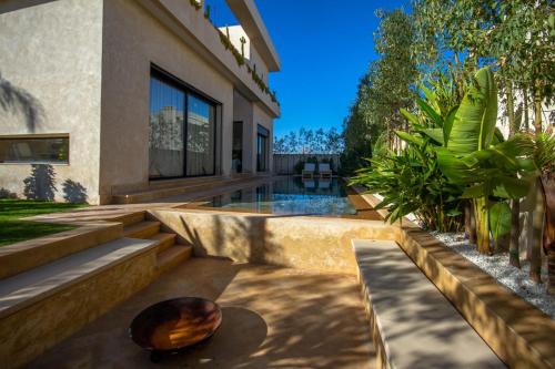 a house with a meditation yard with a rock on the ground at Villa Piscine Privée, Petit déjeuné et ménage inclus in Marrakech