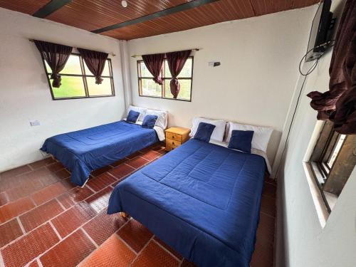 Ein Bett oder Betten in einem Zimmer der Unterkunft Hotel Mahoma