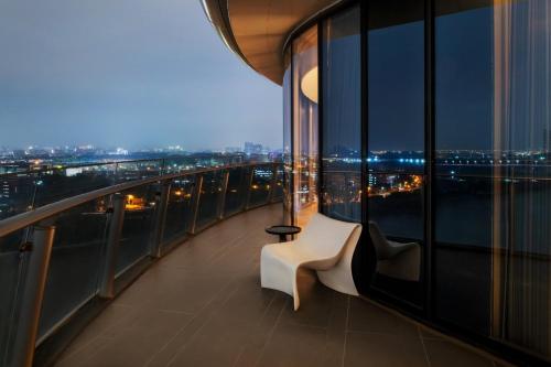 a balcony with a white bench on a building at Vignette Collection The Xanadu Guangzhou, an IHG Hotel in Guangzhou
