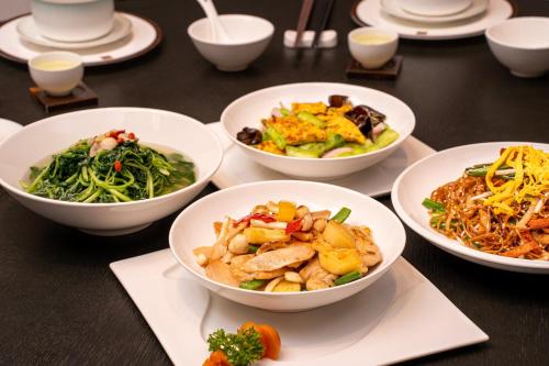 a group of bowls of food on a table at Vignette Collection The Xanadu Guangzhou, an IHG Hotel in Guangzhou