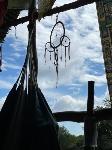 a bag hanging from a pole with a dream catcher at Time Travellers Hostel in Auroville