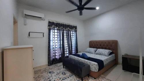 a bedroom with a bed and a ceiling fan at Cozy Homey in Pancur