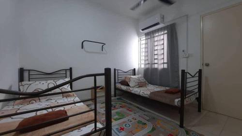 two bunk beds in a room with a window at Cozy Homey in Pancur