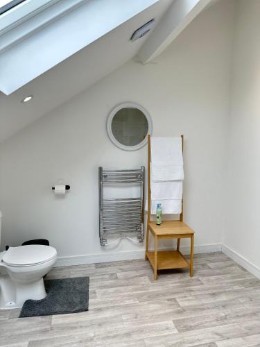 a bathroom with a toilet and a table at The Mayfair Residence