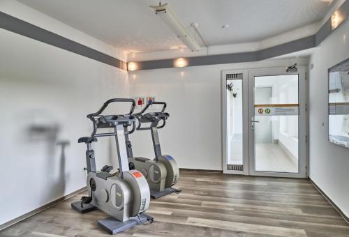 a gym with two exercise bikes in a room at Nautic - 812 in Cuxhaven