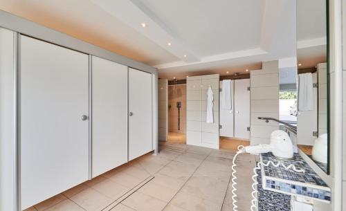 a bathroom with white cabinets and a sink at Nautic - 812 in Cuxhaven