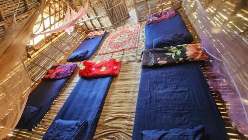 a group of blue pillows sitting on a floor at Time Travellers Hostel in Auroville