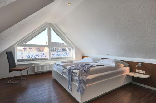 a bedroom with a bed and a large window at Residenz Seegras - 5 in Cuxhaven
