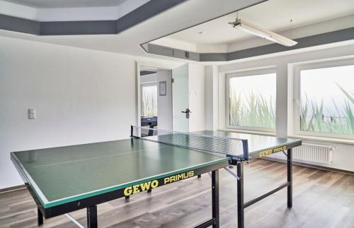 a ping pong table in the middle of a room at Nautic - 116 in Cuxhaven