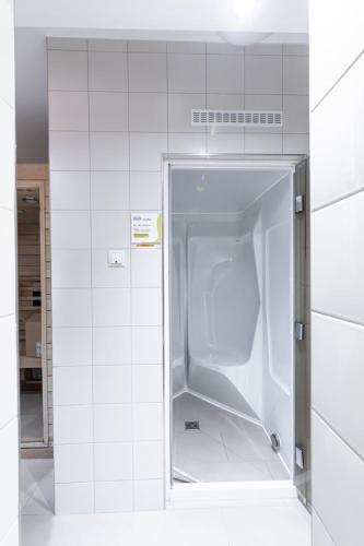 an empty refrigerator in a white tiled room at Hohe Lith - 335 in Cuxhaven