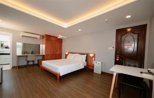 a bedroom with a white bed and a piano at PH Hotel Near SECC Phu My Hung in Ho Chi Minh City