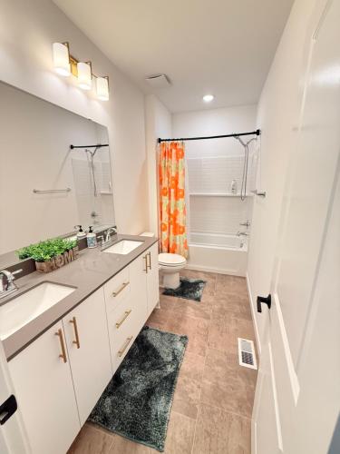 a bathroom with two sinks and a toilet at Cozy Retreat, Room 2, Near Mt Rainier, Seattle, National parks in Bonney Lake