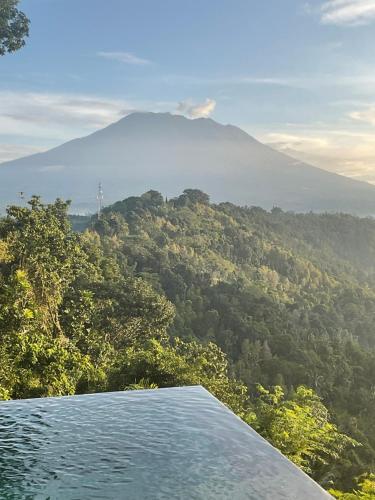 a view of a mountain from a swimming pool at Villa Damai Rohani in Sidemen