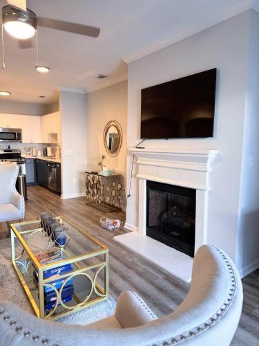 a living room with a fireplace with a tv above it at Dulles Corner Escape - 5 min from Airport in Herndon