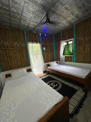 a room with two beds and a window at DOHIKOTORA Eco Camp, Resort & Restaurant in Narjon Basti