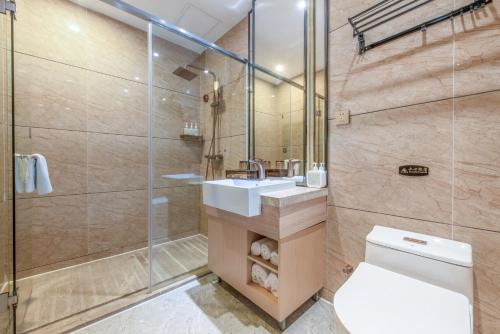 a bathroom with a toilet and a sink and a shower at Trendy Romantic Hotel International Guangzhou Baoneng Performing Arts Center Science City Metro Station Branch - Free Deliver Service to Guangzhou Baiyun International Airport & Free Deliver Service to Canton Fair Complex During Canton Fair Period in Guangzhou