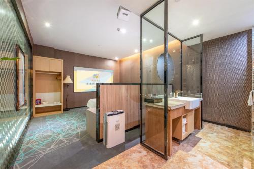 a bathroom with a toilet and a sink at Trendy Romantic Hotel International Guangzhou Baoneng Performing Arts Center Science City Metro Station Branch - Free Deliver Service to Guangzhou Baiyun International Airport & Free Deliver Service to Canton Fair Complex During Canton Fair Period in Guangzhou