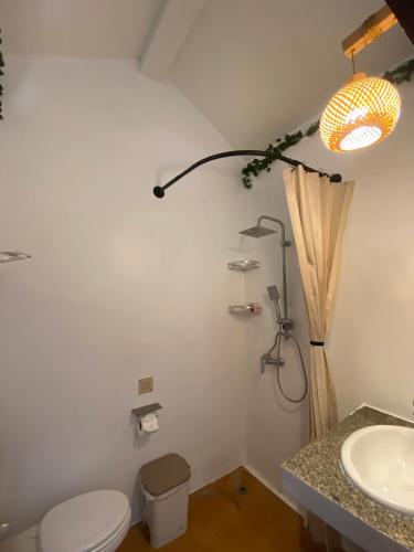 a bathroom with a toilet and a sink at Baan Kiao in Haad Yao