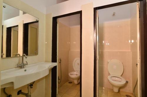 a bathroom with a sink and a toilet and a shower at Gypsy Monkey in Jaipur
