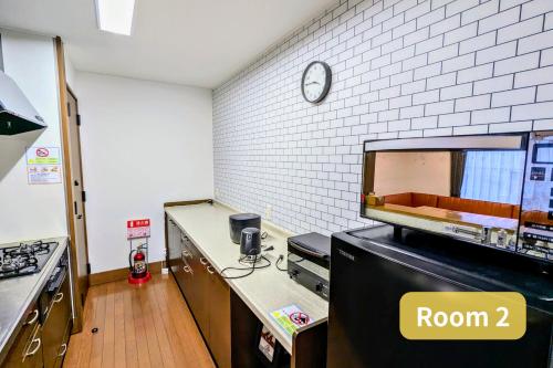 a kitchen with a counter with a room sign on it at Vacation House 1 in Funabashi