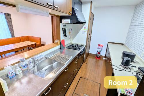 a kitchen with a sink and a stove top oven at Vacation House 1 in Funabashi
