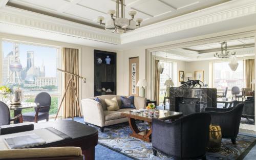 a living room with a couch and a table at The Peninsula Shanghai in Shanghai