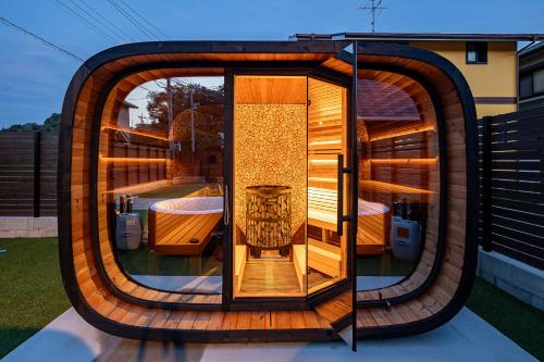 a circular house with a glass door on a roof at Villa & Sauna - NAGIOTO - in Kure