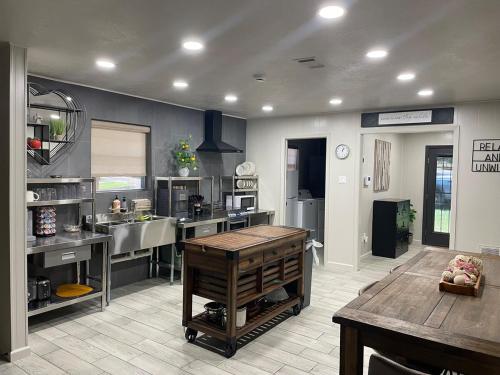 a large kitchen with a sink and a table at HomeSuite Cabin Relaxing Getaway Near Casino in Hugo