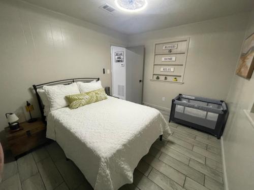 a bedroom with a bed with a white comforter at HomeSuite Cabin Relaxing Getaway Near Casino in Hugo