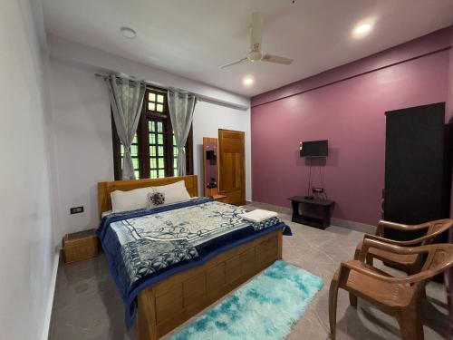 a bedroom with a bed with a purple wall at Dorey Homestay in Dirang Dzong