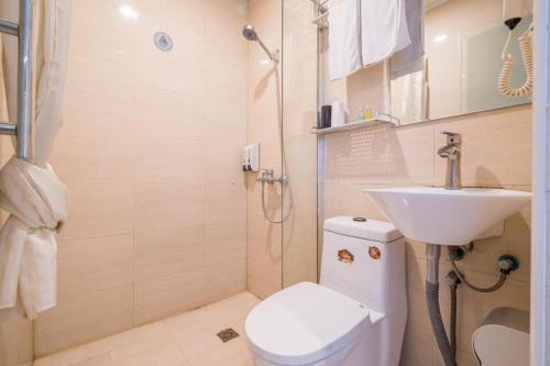a bathroom with a toilet and a sink and a shower at Shanghai Jiejia hotel in Shanghai