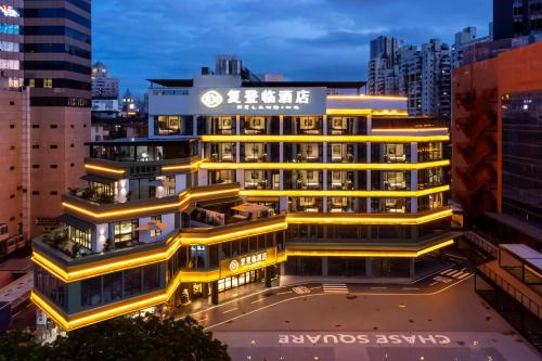 a building with yellow lights on top of it at 珠海复登临酒店 Relanding Hotel in Zhuhai