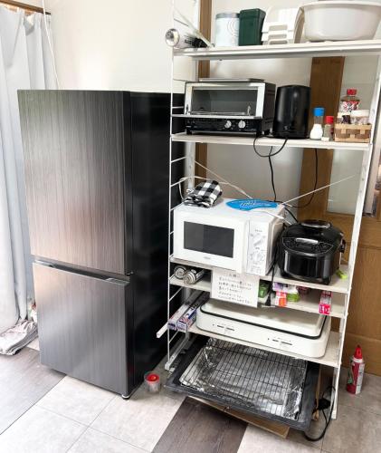 a kitchen with a microwave and a refrigerator at ISU BASE - Vacation STAY 12851 in Shima