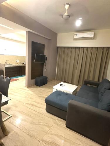 a living room with a couch and a flat screen tv at SUNSET STUDIOS Krishna heights! in Vrindāvan