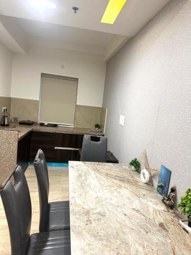an office with a desk and a projection screen at SUNSET STUDIOS Krishna heights! in Vrindāvan