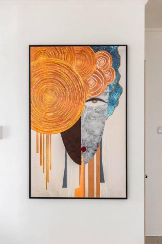 a painting of a woman with orange hair on a wall at Amazing luxurious studio Space Available in Accra